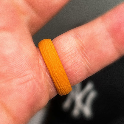 Amber orange silicone ring close-up on hand
