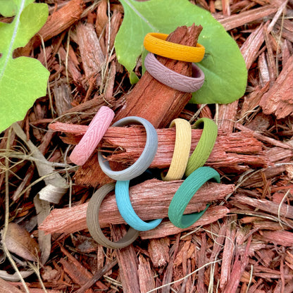 Woman's hand wearing woodgrain silicone rings
